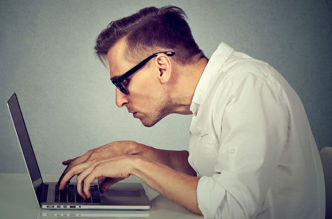 Man with bad posture working on laptop