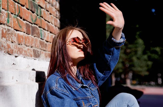 Woman shielding eyes from sunlight.